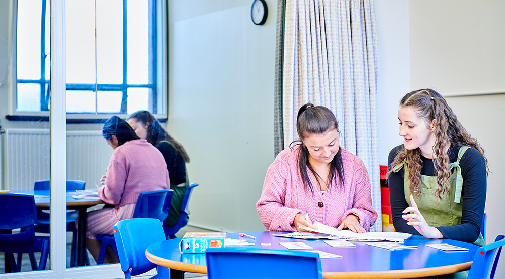 Two students working together at a desk